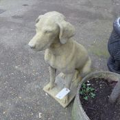 A pair of Cotswolds style stone garden dog statues