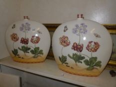 A pair of moon flask vases with floral and butterfly decoration