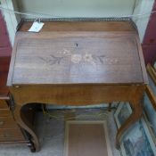 A C19th French walnut bureau de dame the fall front enclosing fitted interior raised on cabriole