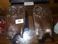 A pair of bronze cast plaques of owls