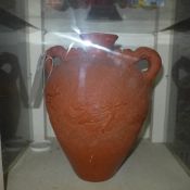 A terracotta Chinese style vase with dragon handles