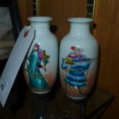 A pair of hand painted miniature Chinese vases