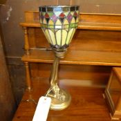 A Tiffany style lamp with nude female support