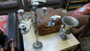 A silver plated five branch candelabra and an urn