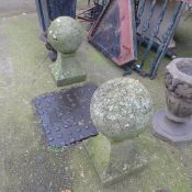 A pair of stone garden spherical statues