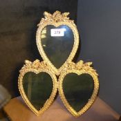 A gilted heart shaped triple photo frame