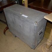 An aluminium flight case raised on castors
