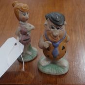A pair of rare bisque Flinstone figurine