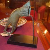 A bronze sculpture of a hand on black st