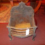 A cast iron fire grate with shell and c