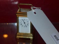 A brass miniature carriage clock with en