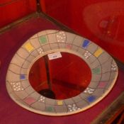 A 1950`s designer pottery mirror with ci