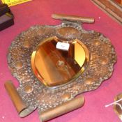 An Arts and Crafts planished wall mirror