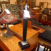 A pair of black porcelain column form ta