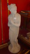 A stoneware garden statue of a maiden