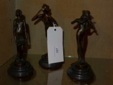 Three small bronzes of maidens on marble