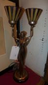 A bronzed table lamp in the form of a ma