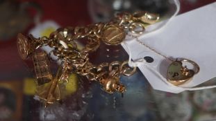A 9ct gold charm bracelet with charms in