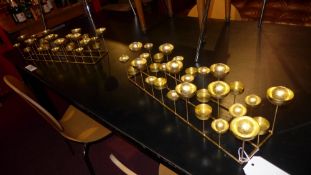 A pair of gold glitter painted tea light