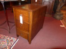 An oak three drawer bedside chest