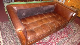 A three seater sofa of angular form upho