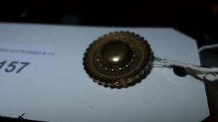 A Victorian yellow metal (most likely gold) mourning brooch with safety chain