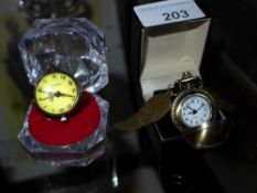 A bulls-eye style ladies fob watch with chain and one similar