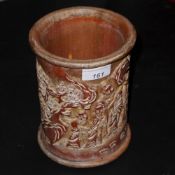 A Chinese carved bamboo brush pot with social scenes in relief