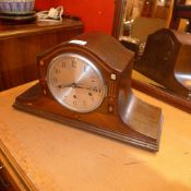 A 1930's inlaid oak cased mantel clock with circular steel dial