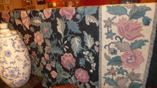 A William Morris style needlepoint tapestry the cream field decorated with flowers in a black border
