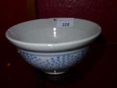 An early C19th Chinese bowl glazed white with pale blue decoration