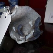 A carved agate paperweight in the form of four bearded lizards on a rock