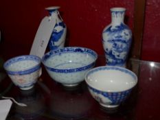 A collection of mostly antique Oriental blue and white items including two small vases