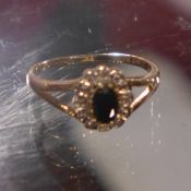 A ladies 9ct gold sapphire and diamond chip ring