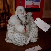 A porcelain bronze Buddha heightened in gilt