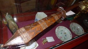 A carved hardwood Samoan war club