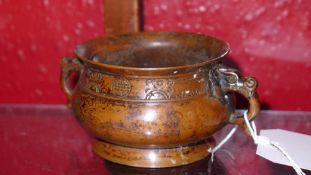 A Chinese bronze incence burner with twin dragon form handle