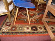 An Afghan style carpet the terracotta ground with green and brown decoration