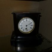 A Victorian slate marble mantle clock with circular Roman numeral dial including key and pendulum