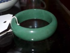 A Chinese green jade bangle