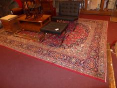 An extremely fine central Persian Kashan carpet signed 393 x 275 cm bearing central floral pendant