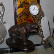 A cast metal elephant form clock with swinging movement