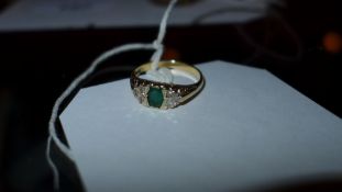 A 9ct gold ladies ring inset with emerald and diamonds