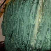 A pair of green damask curtains