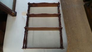 A four tiered mahogany open wall hanging shelves