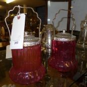 A pair of glass cranberry biscuit barrel