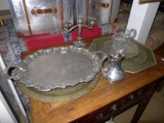 A collection of twin handle trays, candelabra, glass jug and silver plated jug