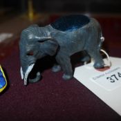 A bronzed elephant pin cushion