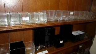 A large collection of glass cuboid vases
