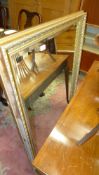 A gilt wall hanging mirror with bevelled